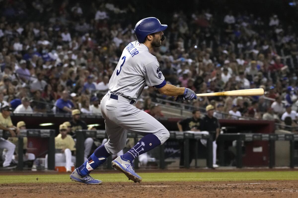 The Dodgers' Chris Taylor watches his two-run triple against the Arizona Diamondbacks in the seventh inning.