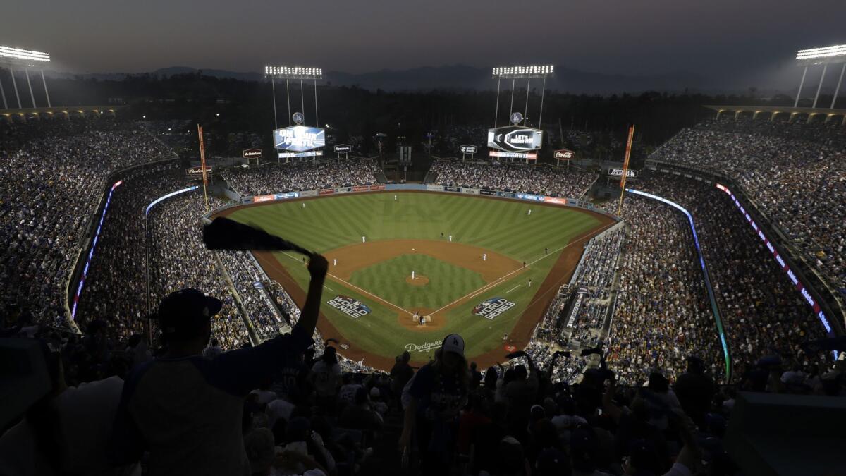Fans cheer from the top of Dodger Stadium during Game 4 of the World Series between the Boston Red Sox and Dodgers on Oct. 27.