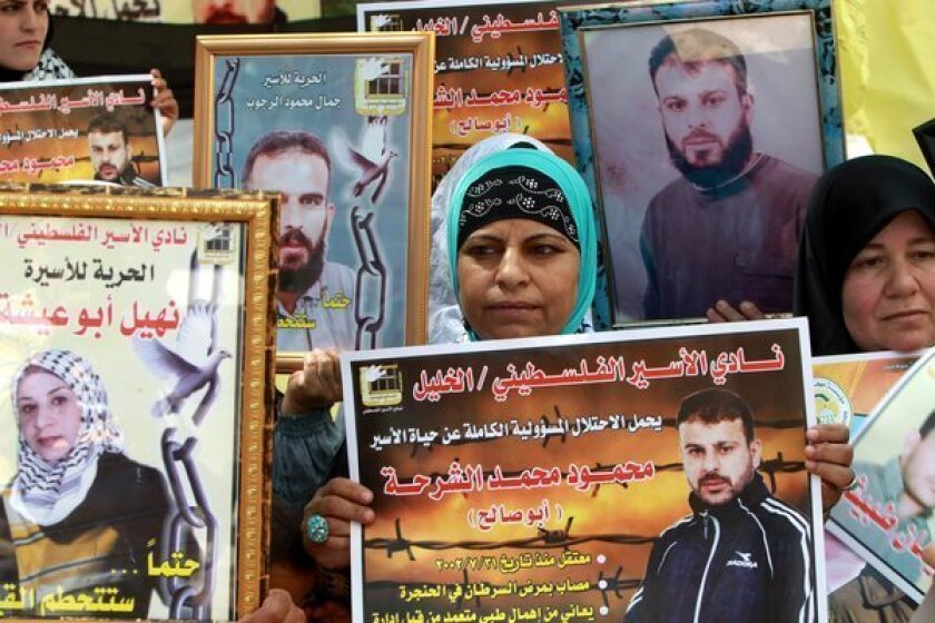 Palestinians hold a rally Monday in the West Bank city of Hebron to show solidarity with prisoners held by Israel.