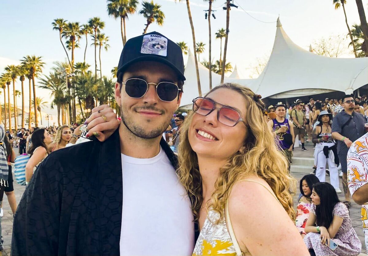 Alec Mitchell and Dillan Boada with her arm around him among crowds at Coachella. 
