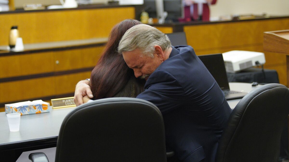 Attorney Keith Greer hugs his client, Mary Zahau-Loehner, after a jury verdict was read in San Diego Superior Court finding Adam Shacknai legally responsible for the death of Rebecca Zahau.