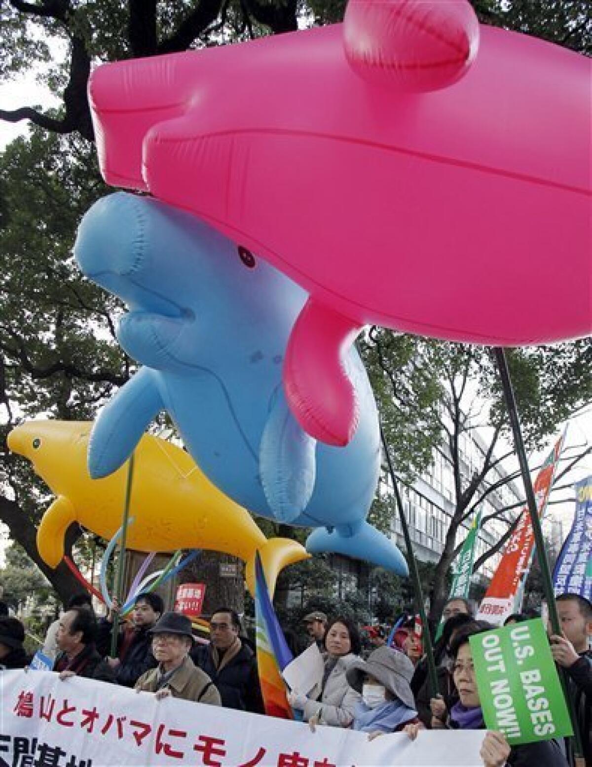 Demonstrators with balloons in the shape of dugong gather at a rally, protesting against relocation of a U.S. Marine base stationed on the southern island of Okinawa, in Tokyo Saturday, Jan. 30, 2010. Japanese Prime Minister Yukio Hatoyama said Friday he would decide by the end of May on where to relocate the U.S. Marine Airfield Futenma in Okinawa that has strained ties between the nations. (AP Photo/Koji Sasahara)