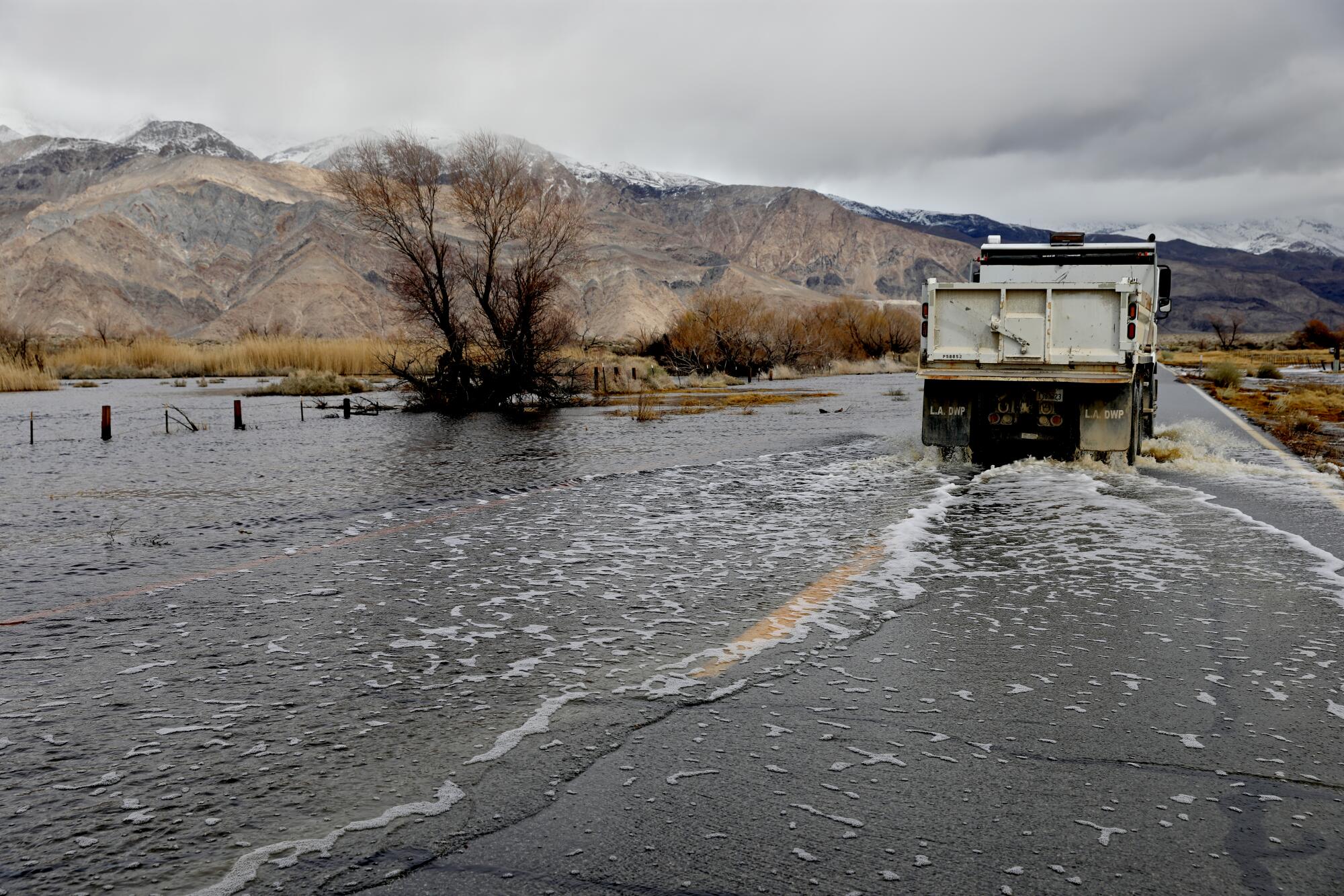 A vehicle driving on a flooded road