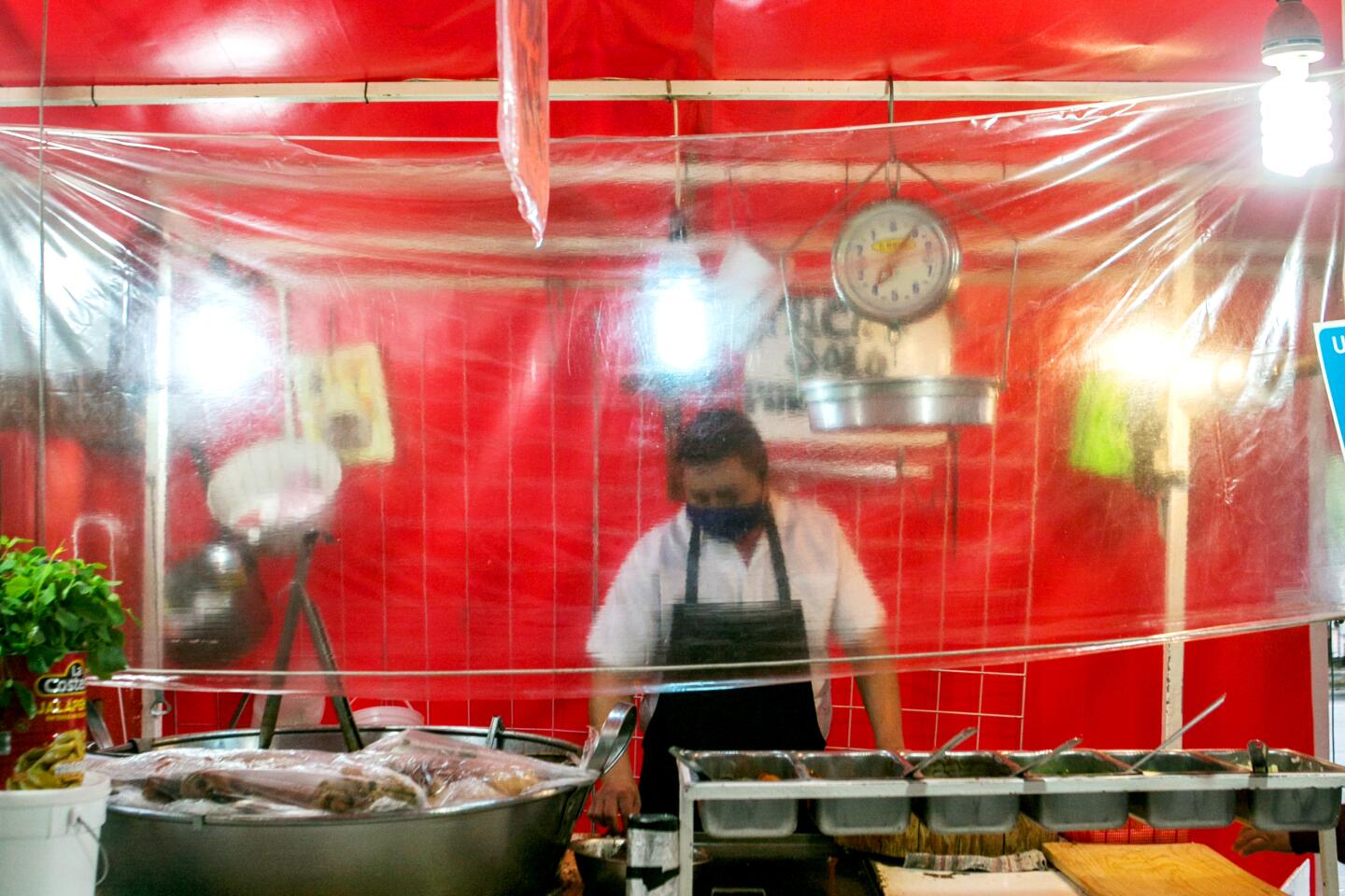 "We haven't had very many customers lately," says Javier Hernandez of the carnitas stand he runs in Mexico City.