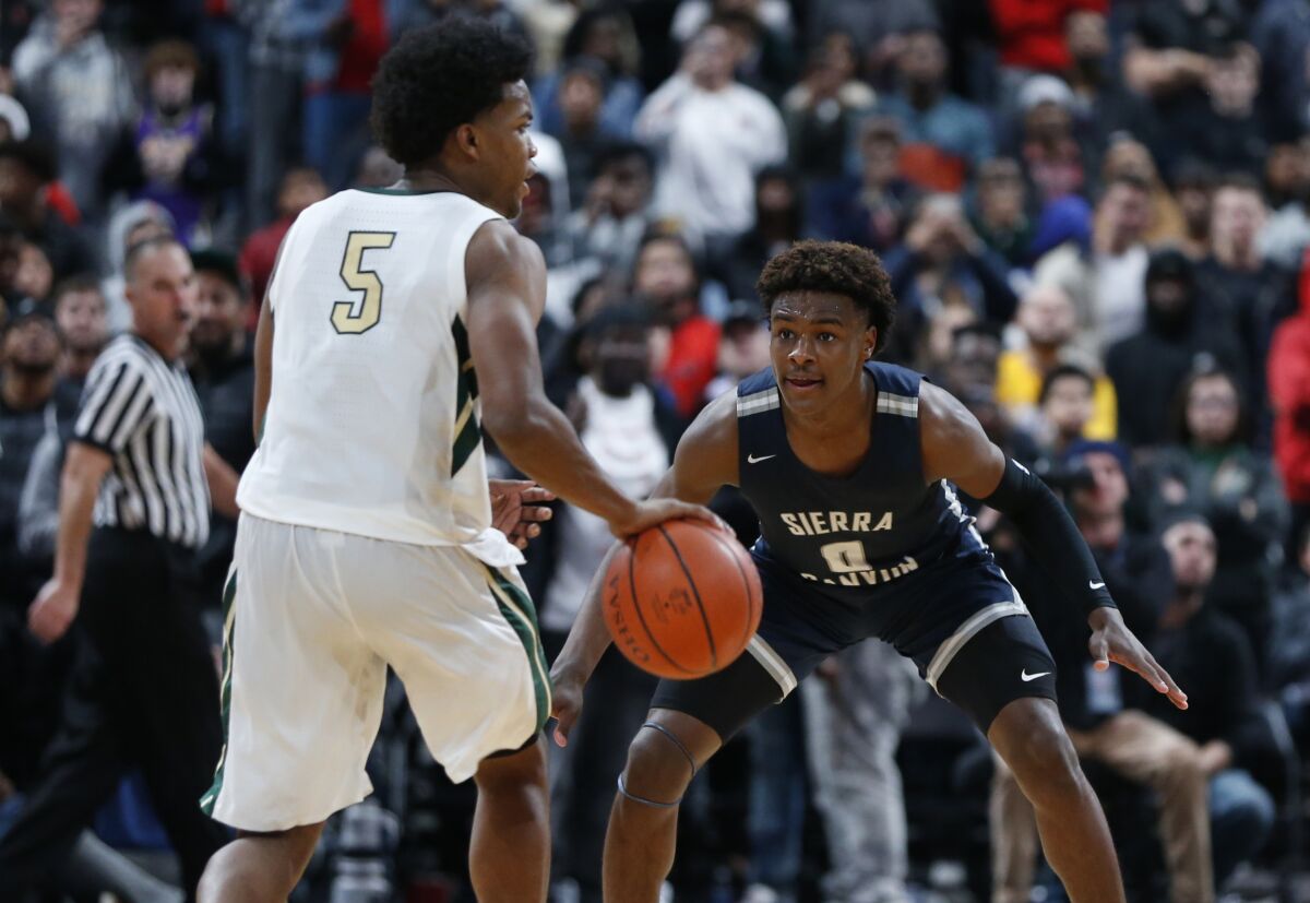 Sierra Canyon's Bronny James plays defense against Akron (Ohio) St. Vincent-St. Mary's Isaiah Ingol during the second half of the Trailblazers' win on Saturday.