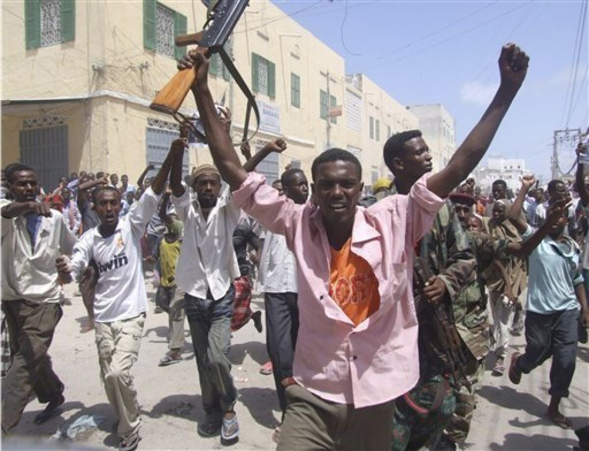 Protesters shout slogans in Mogadishu, Somalia, Friday, June 10, 2011, where they took to the streets for the second day in support of current Prime Minister Mohamed Abdullahi Farmajo. A new accord extending the government's term by a year requires Prime Minister Mohamed Abdullahi Mohamed to resign in a month, but Mohamed is popular with many Somalis because he has managed to pay salaries for government workers and soldiers and attack corruption since he came to power in October last year. (AP Photo/Mohamed Sheikh Nor) ?