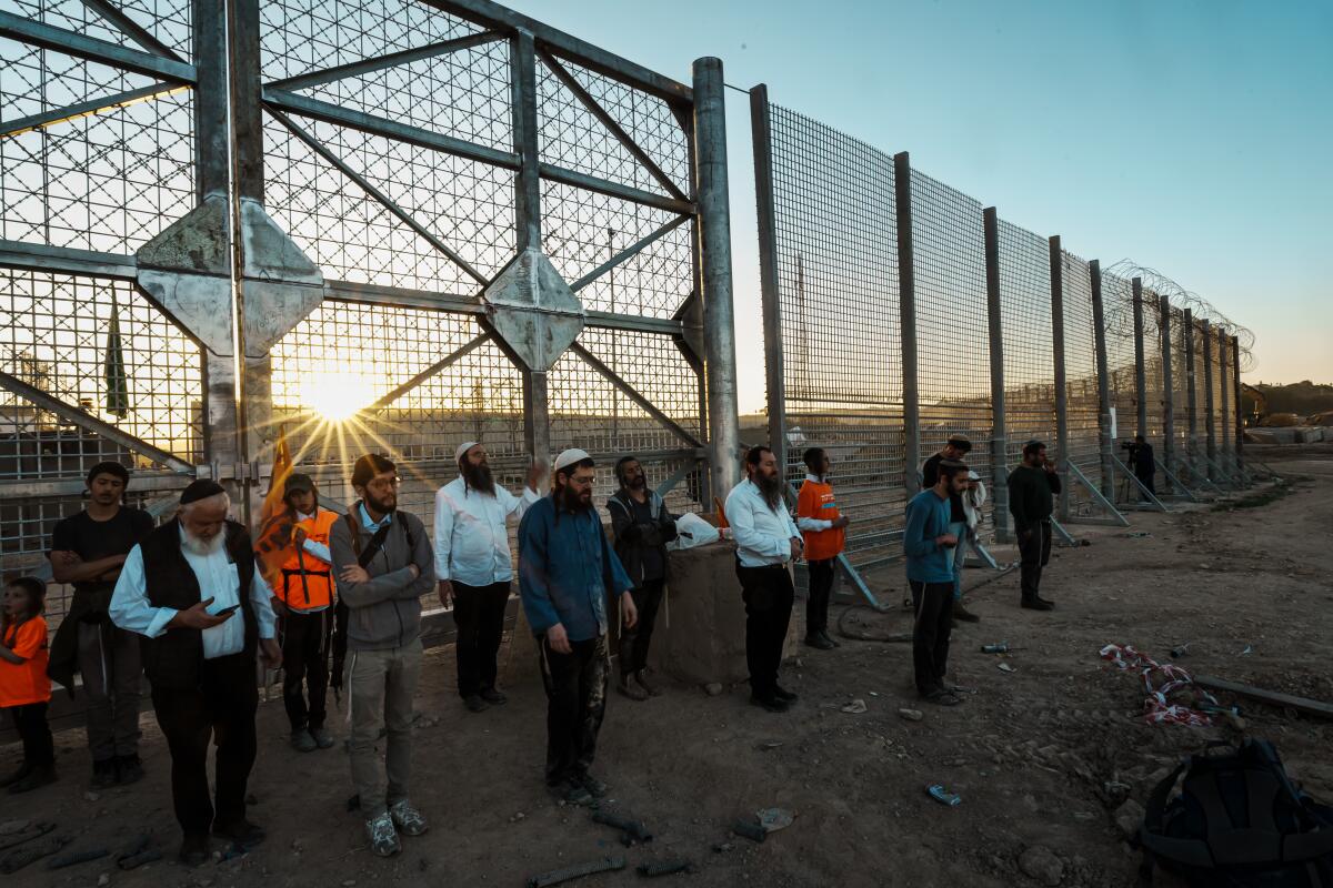  Right-wing activists pray outside the Gaza border fence at Erez Crossing in Israel on Feb. 29.