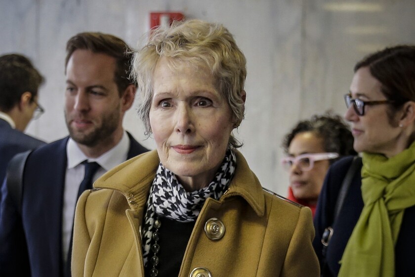 FILE - E. Jean Carroll, center, waits to enter a courtroom in New York for her defamation lawsuit against President Donald Trump, March 4, 2020. At a hearing Friday, Dec. 3, 2021, lawyers for former President Trump argued before a federal appeals court that the U.S. government should take his place as the defendant in the lawsuit filed by Carroll, who accused him of rape. (AP Photo/Seth Wenig, File)