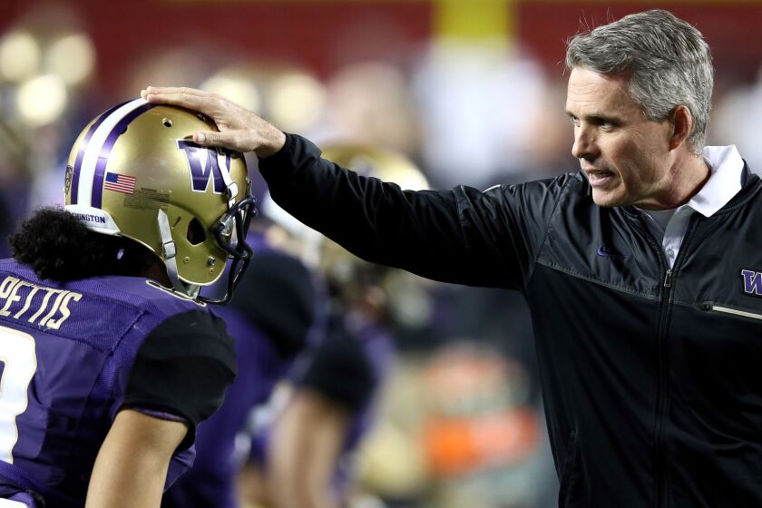 Coach Chris Petersen and his Washington Huskies lost only to USC this season. They squeezed into the College Football Playoff.