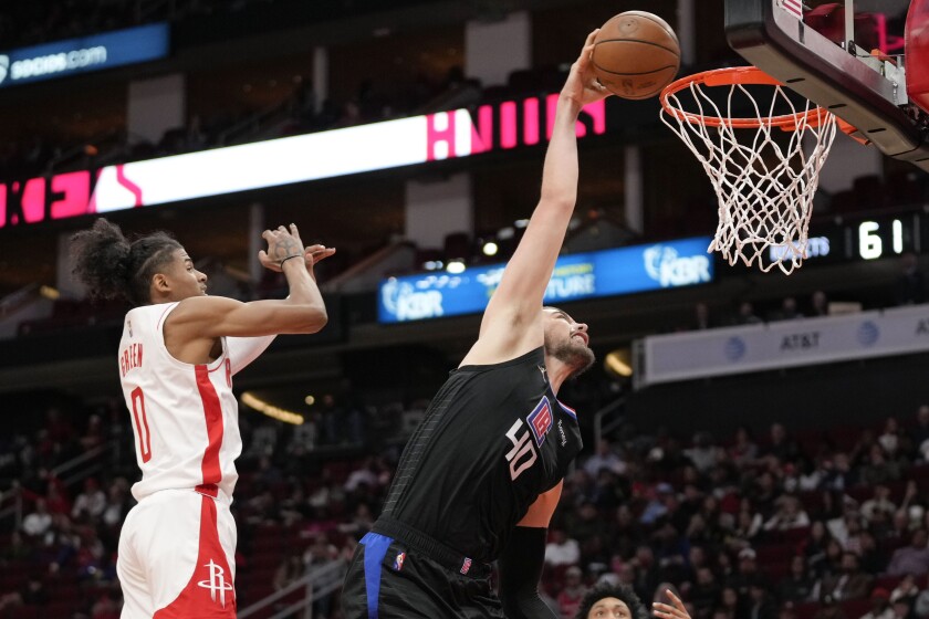 Los Angeles Clippers center Ivica Zubac, right, dunks as Houston Rockets guard Jalen Green defends during the second half of an NBA basketball game, Sunday, Feb. 27, 2022, in Houston. (AP Photo/Eric Christian Smith)