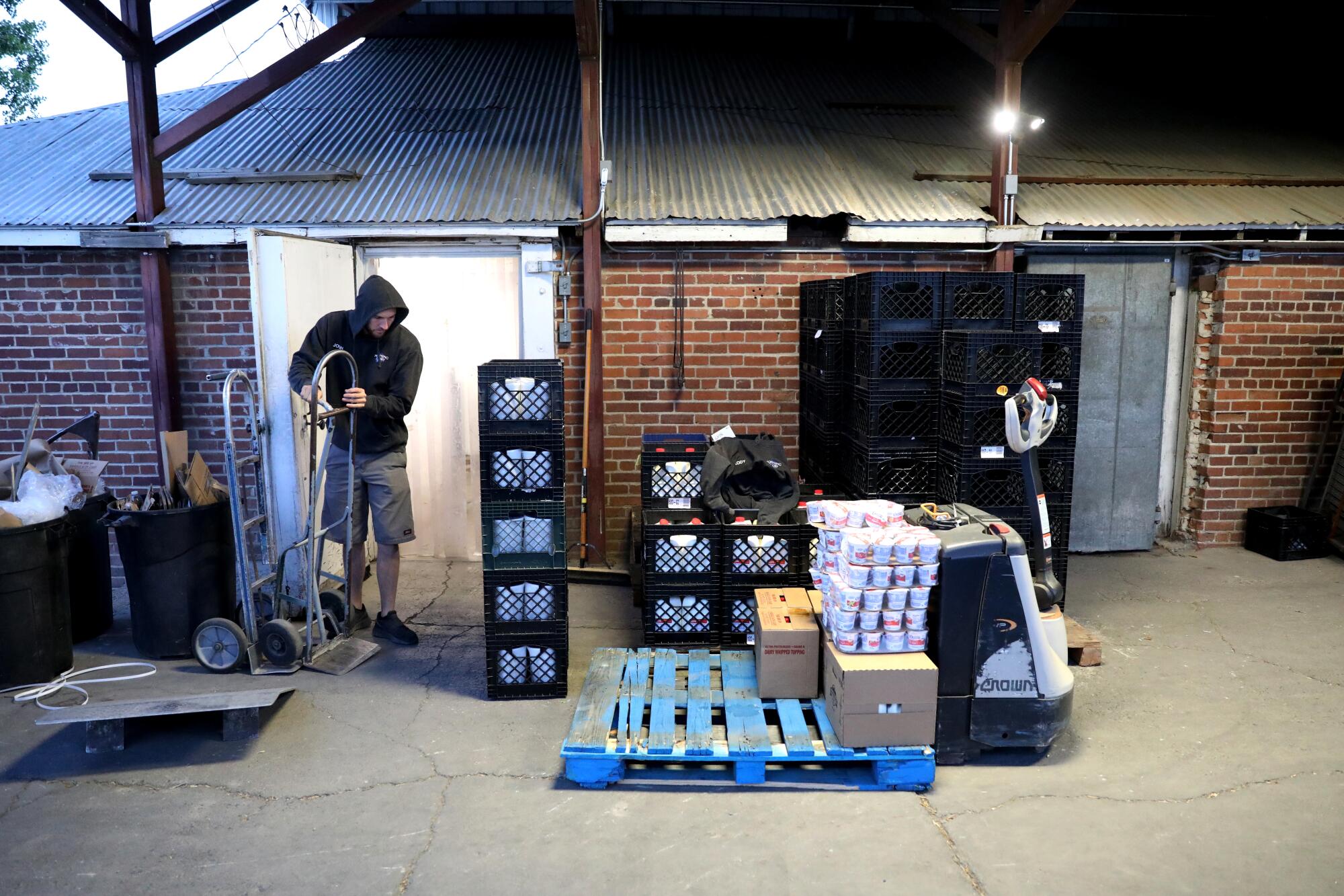 Josh McKernan, owner of Morning Glory Dairy, unloads a shipment of dairy products in Susanville.