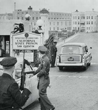 A Los Angeles County sheriff's van passes through the gates of San Quentin State Prison.