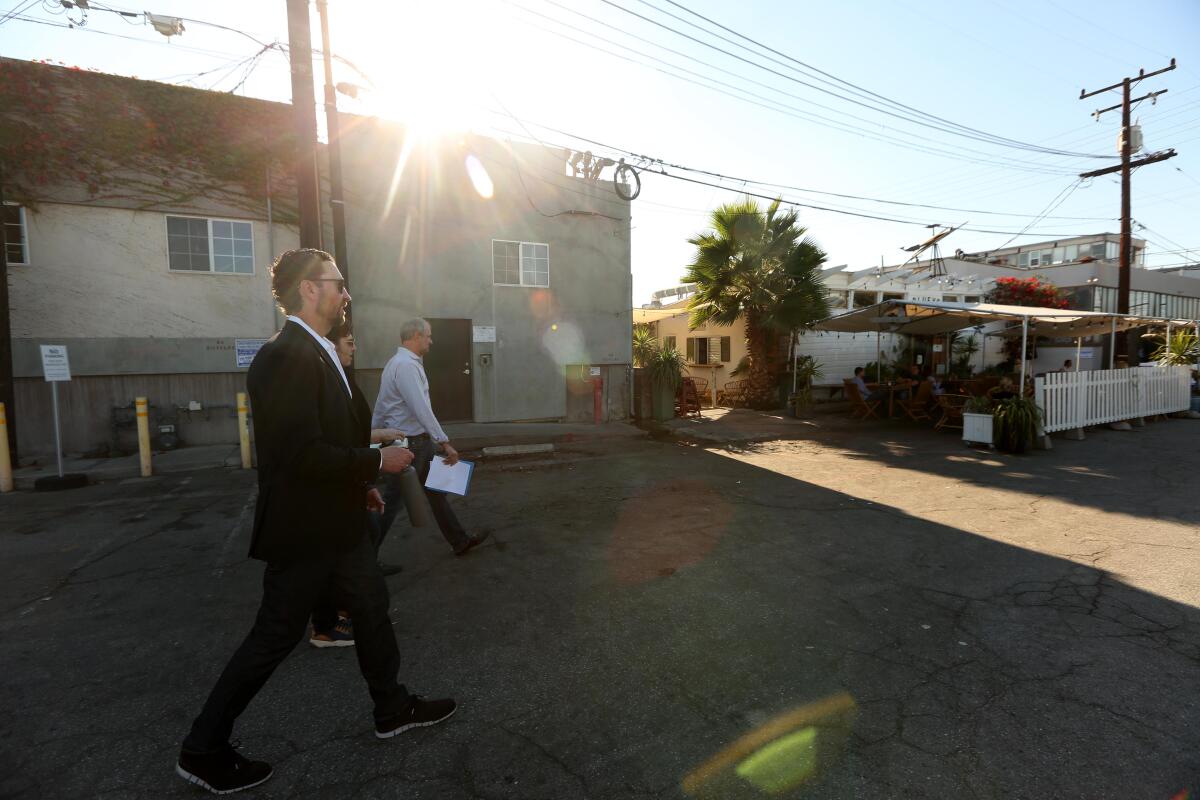 Scott Walter and another man walk across a Santa Monica lot.