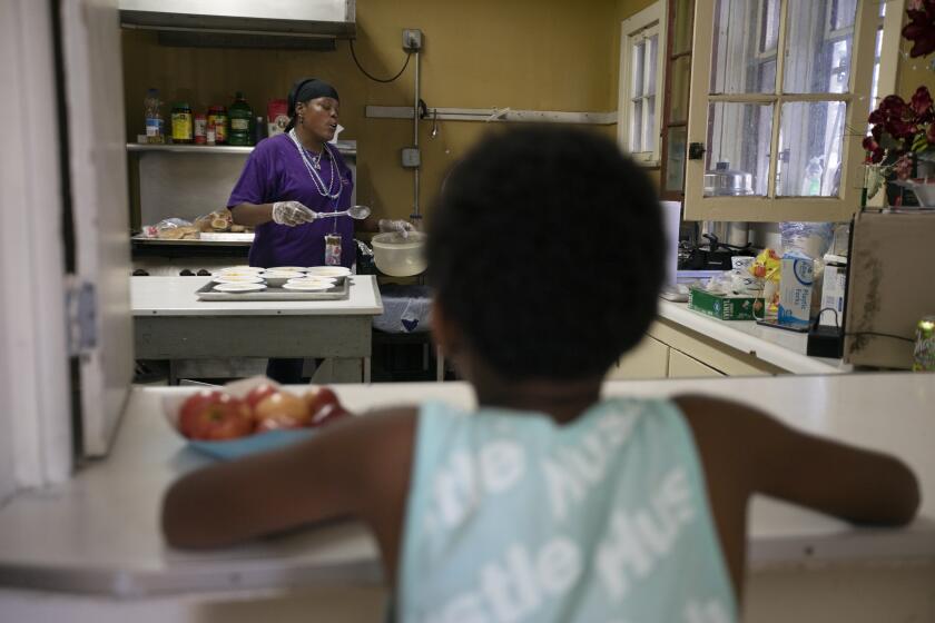 LOS ANGELES, CA JULY 24, 2019: Yvette Grant, left, known as “Big Mama” is doing volunteer work at her church’s day camp in South Los Angeles July 24, 2019. She is preparing snacks for the kids. She and her friend Top Shelf were discussing what they might want to do for work in the future. Big Mama said she might want to work with children. Top Shelf mentions possibly wanting to work as a crossing guard. This is a big transition for both of them as they were both recently homeless. (*Editors Note: Contact photo editor Mary Cooney should you have any questions. Please do not use this image for other stories. This image is for a future project by writer Tom Curwen.) (Francine Orr/ Los Angeles Times)