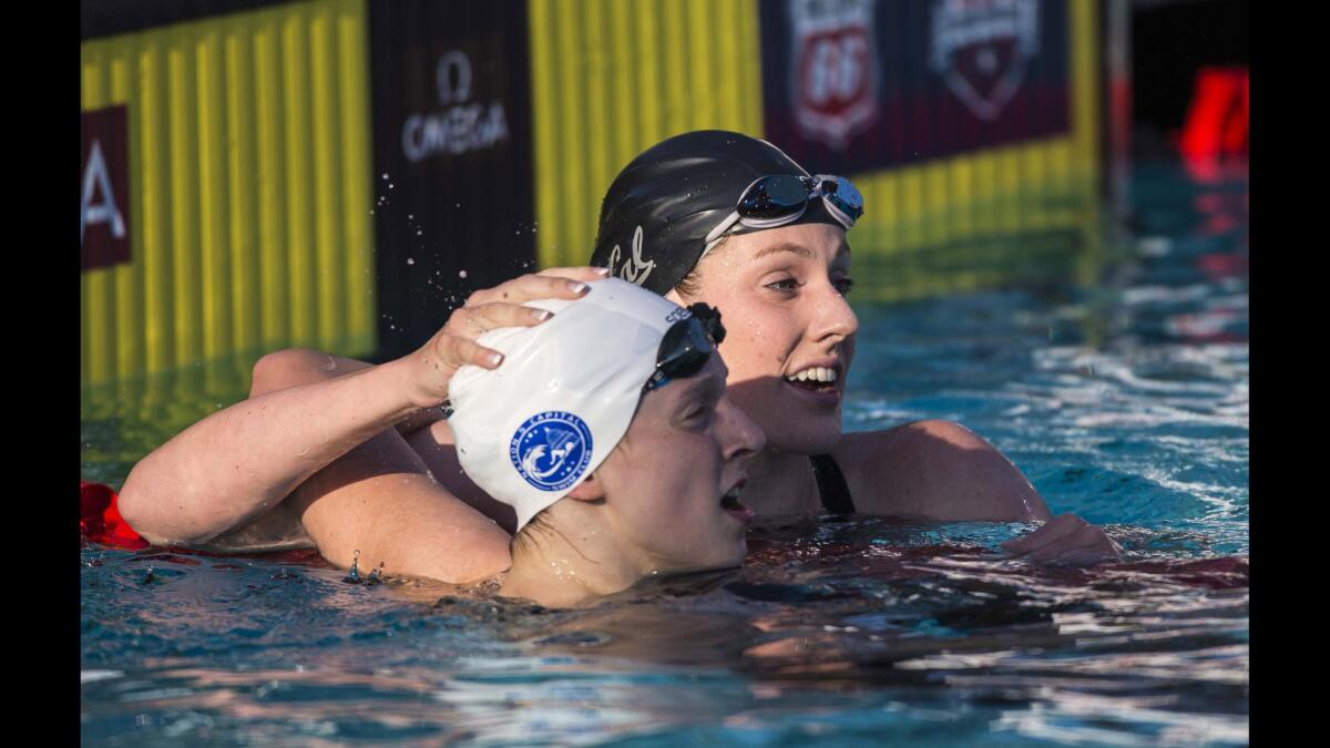 Missy Franklin, right, in lane 5 and Katie Ledecky, left, in lane 4 check the clock after Ledecky's win in the women's 200 meter freestyle final Thursday at the William Woollett Jr. Aquatics Center in Irvine.