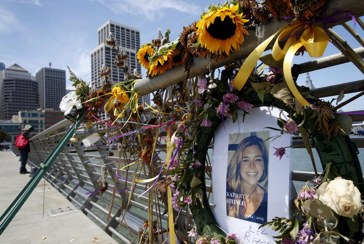 In this July 17, 2015, file photo, flowers and a portrait of Kate Steinle remain at a memorial site on Pier 14 in San Francisco.