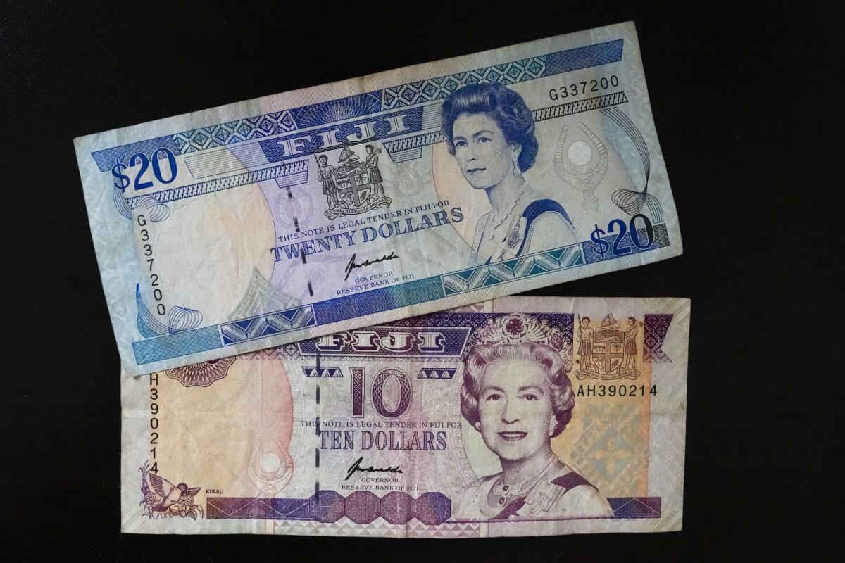 Fiji $10 and $20 bills with images of Queen Elizabeth II.