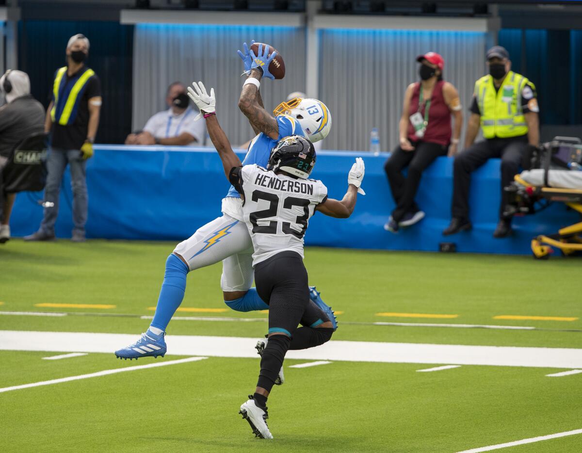 The Chargers' Keenan Allen hauls in a pass over Jaguars cornerback CJ Henderson in the first half at SoFi Stadium. 
