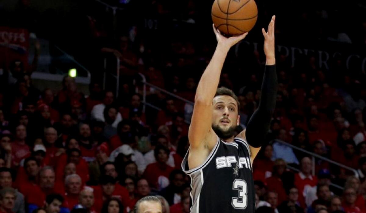 Clippers Coach Doc Rivers is concerned over the number of open shots, like this one by forward Marco Belinelli, the Spurs had.