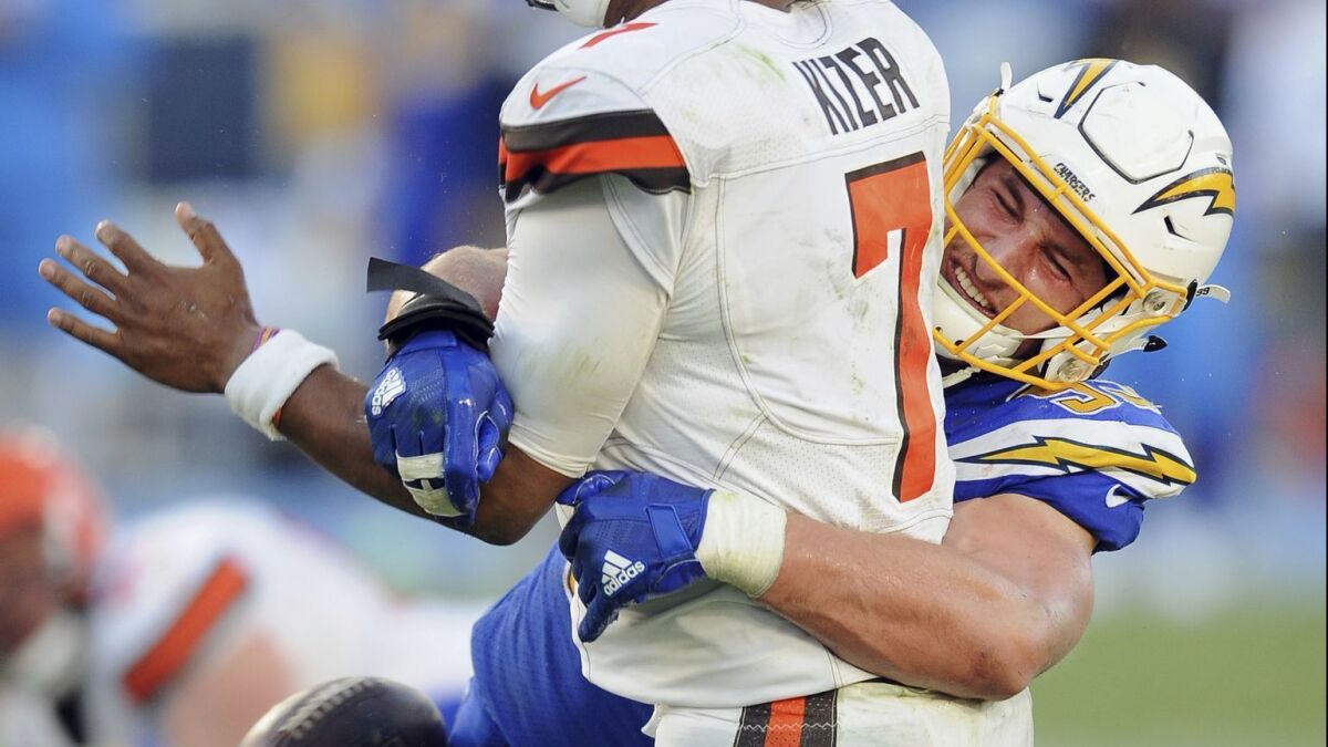 Chargers defensive end Joey Boss causes a fumble as he hits Browns quarterback DeShone Kizer in a game last season.