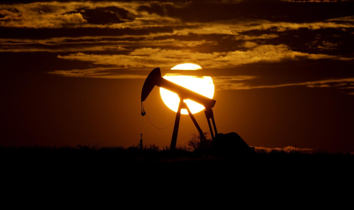 FILE - In this Wednesday, April 8, 2020, file photo, the sun sets behind an idle pump jack near Karnes City, USA. Oil prices pressed higher Monday, March 8, 2021, after strikes on major oil facilities in Saudi Arabia, the world’s largest oil exporter, shook energy markets. (AP Photo/Eric Gay, File)