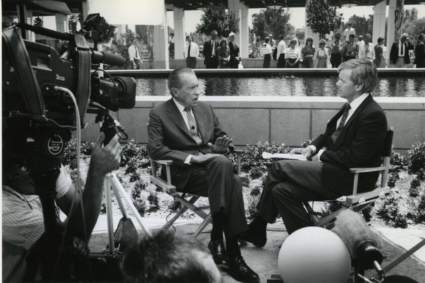 Cameras roll as former President Richard Nixon is interviewed by NBC journalist Tom Brokaw by the library's reflecting pool.