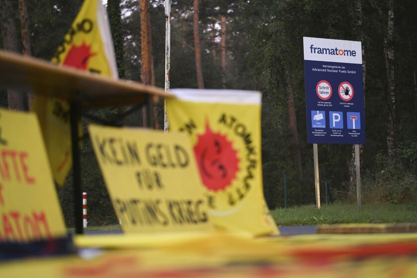 FILE - Protest posters are placed in front of the fuel element fabrication plant of the 'framatome' company in Lingen, Germany, on Sept. 12, 2022. German officials have criticized plans by French firm Framatome to produce nuclear fuel in a joint venture with Russia's Rosatom at a facility in western Germany, and say they will consider whether an application to do so can be rejected. (Lars Klemmer/dpa via AP, File)