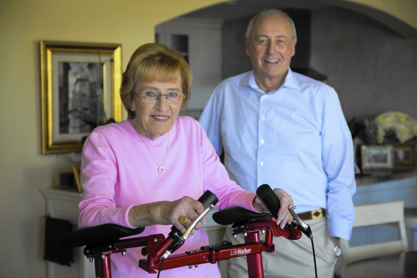 Jean Purcell uses the LifeWalker, an upright medical walker designed by her husband, David Purcell, right, founder and CEO of ProtoStar, the San Diego company that makes the LifeWalker.