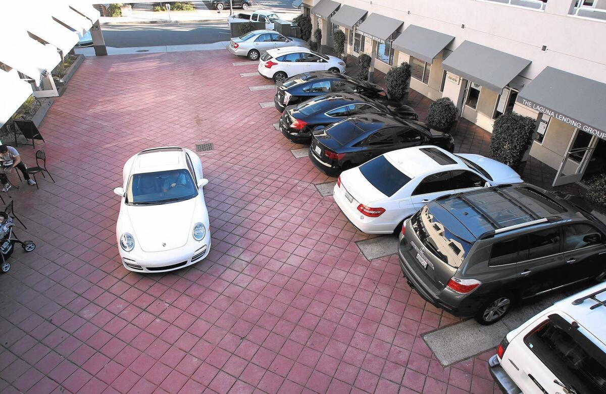 Cars fill every parking space in The Plaza shopping center where the Shirley's Bagels customers park.