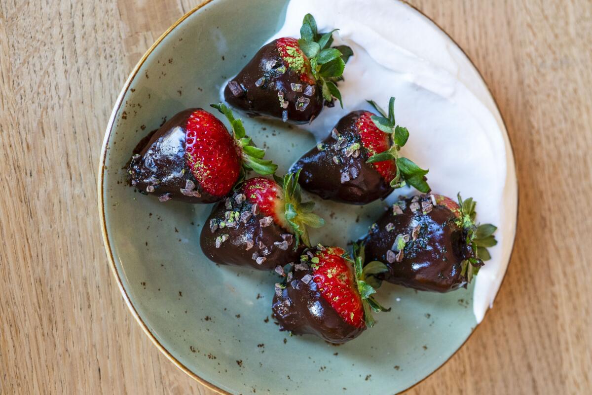 A plate with six chocolate-dipped strawberries