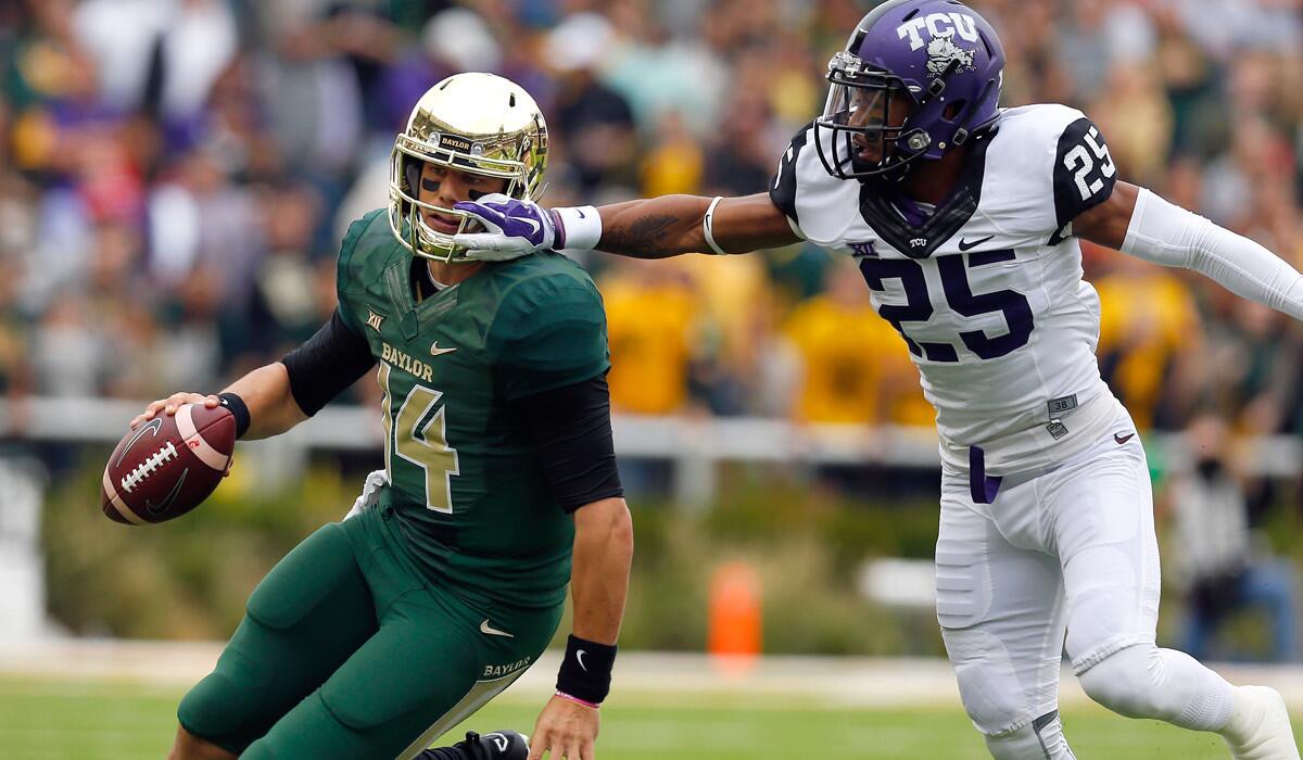 Baylor quarterback Bryce Petty tries to evade Texas Christian cornerback Kevin White on a scramble in the first half Saturday.