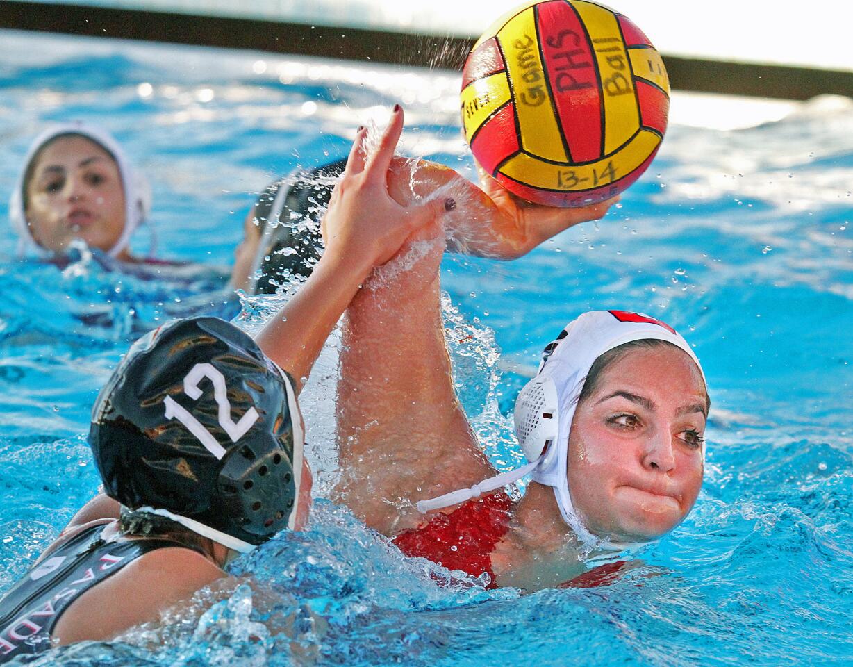 Glendale's Melanie Aghazarian shoots to score against Pasadena Irma Sarac in a Pacific League girls water polo game at Pasadena High School on Tuesday, January 14, 2014. (Tim Berger/Staff Photographer)