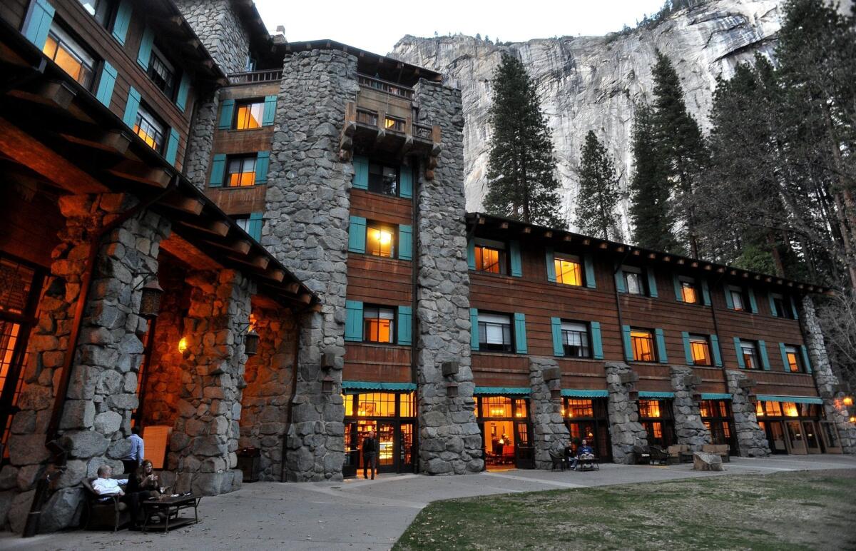 The historic Ahwahnee Hotel is lit up as dusk falls over Yosemite National Park on March 24, 2014. The names of iconic hotels and other facilities in the park will soon change in an ongoing battle over who owns the intellectual property.