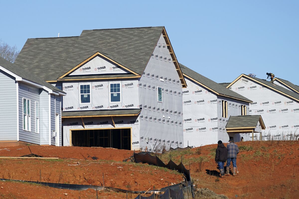 New homes are seen under construction in Mebane, N.C., Monday, Jan. 10, 2022. Construction of new homes in the U.S. rose again in December as builders ramp up projects amid a persistent shortage of homes. The December increase left home construction at a seasonally adjusted annual rate of 1.70 million units, the Commerce Department reported Wednesday, Jan. 19, the third straight monthly gain. .(AP Photo/Gerry Broome)
