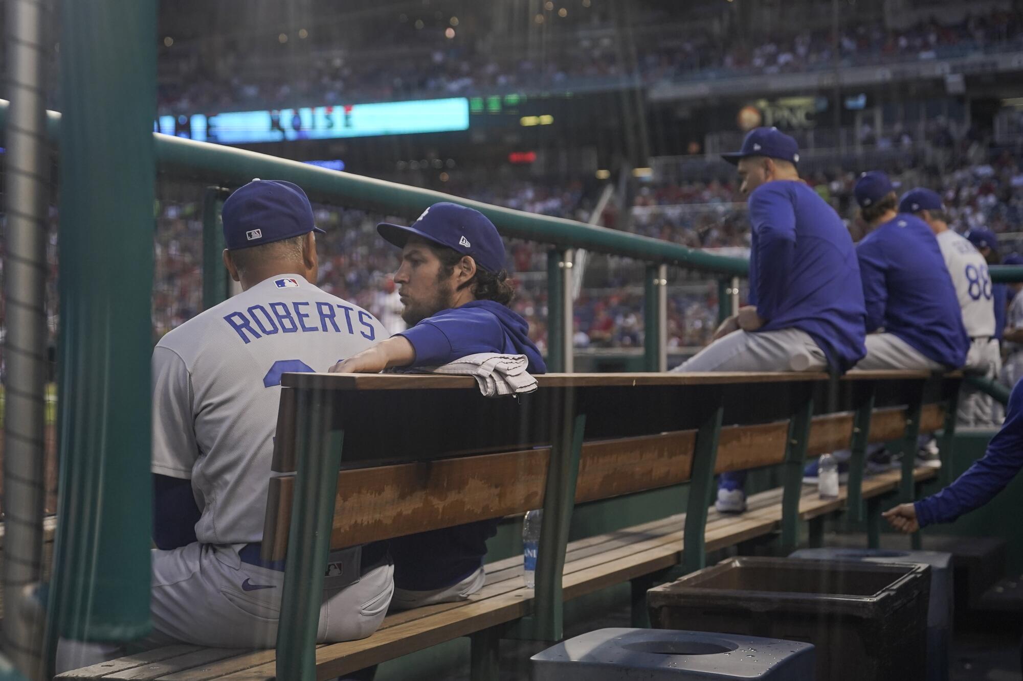 Dodgers pitcher Trevor Bauer sits with manager Dave Roberts during a game in Washington on July 1.