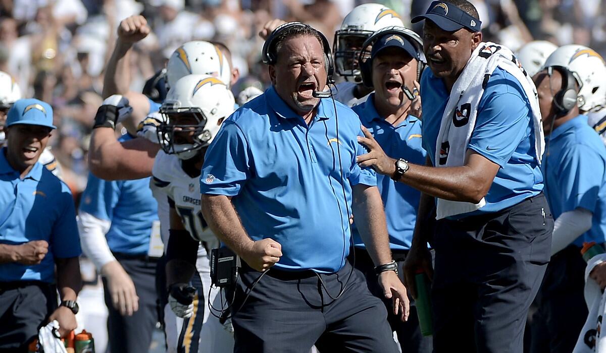 Chargers defensive coordinator John Pagano (center) celebrates a defensive stop against the Seattle Seahawks two weeks ago at Qualcomm Stadium in San Diego.
