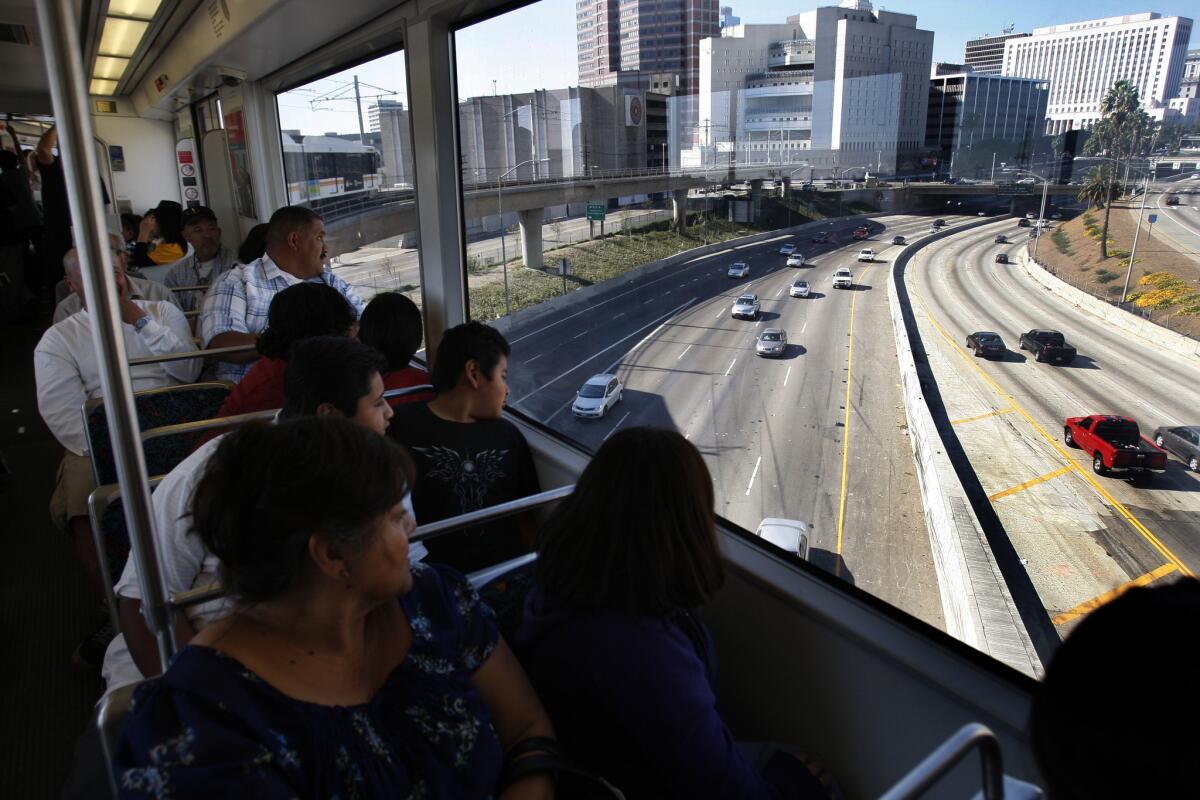 Metro officials say a concrete overpass support will have to be repaired. Above, passengers look over the 101 Freeway on the debut for the Metro Gold Line's east side extension in 2009.
