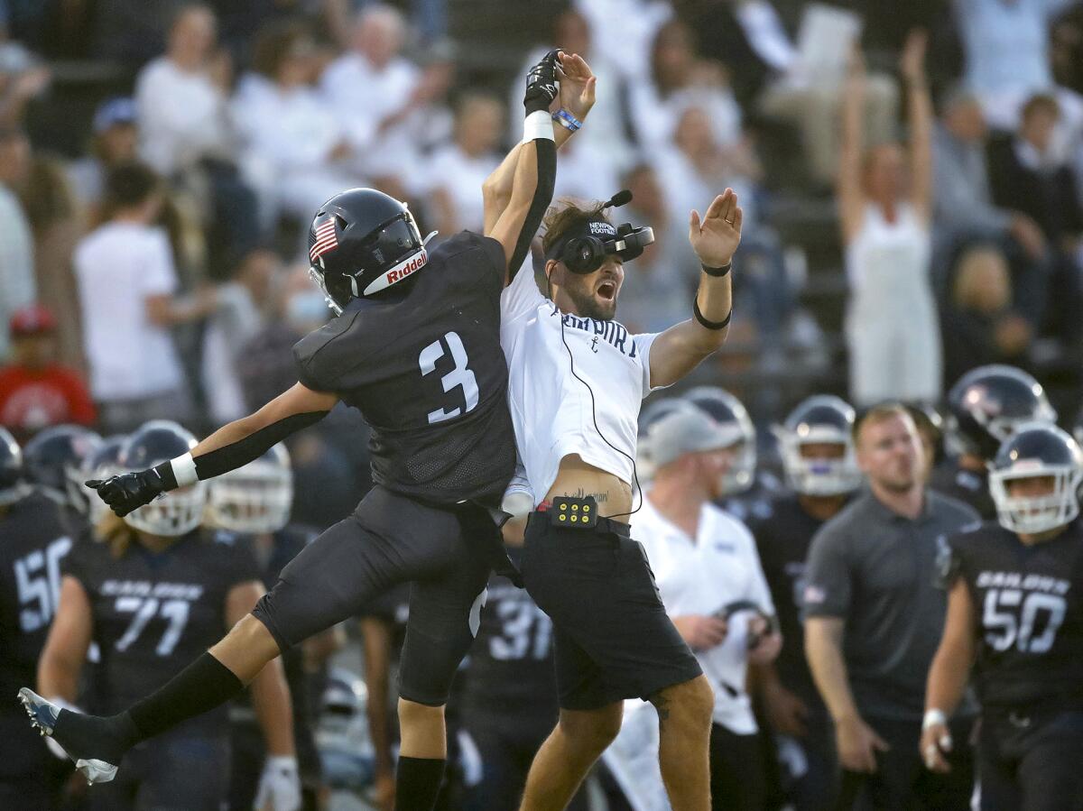 Johnny Chaix (3) high-fives a coach as he heads to the sidelines after he tipped a punt against Marina on Thursday.