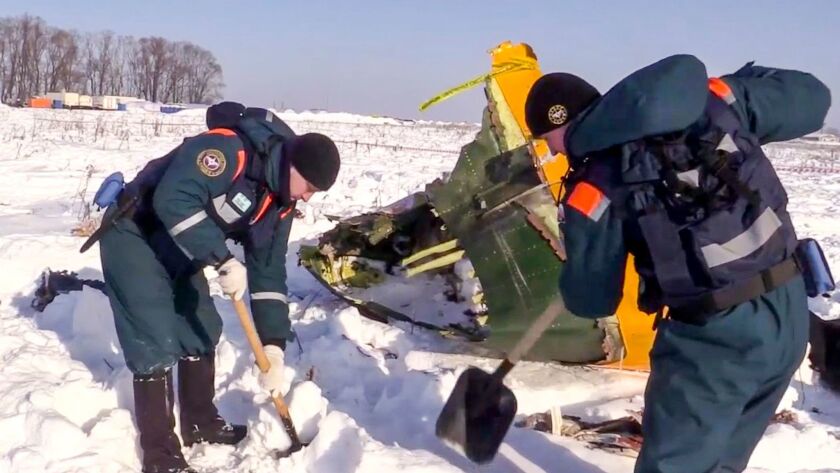 An emergency team works at the site of a AN-148 plane crash in Stepanovskoye village on Feb. 13.