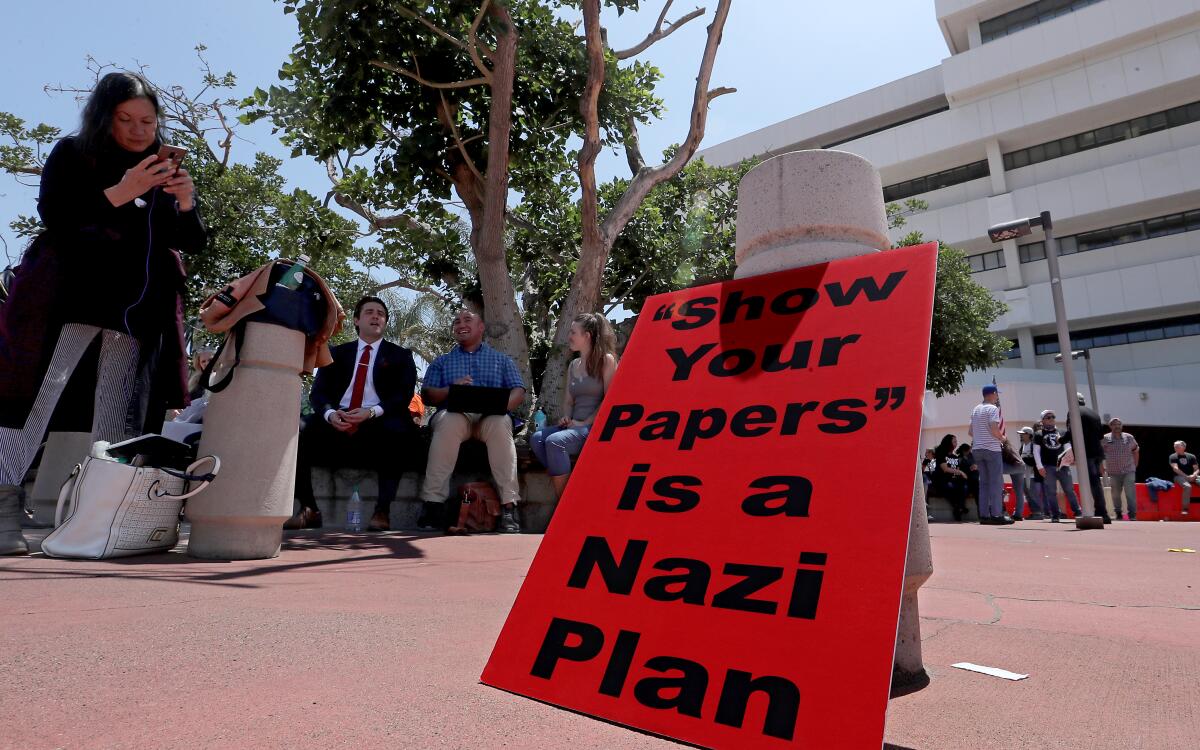 Protesters mill around around the Orange County Administration Building, where the County Board of Supervisors 