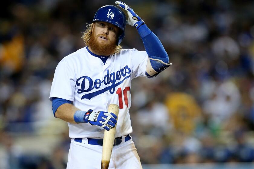 Dodgers third baseman Justin Turner adjusts his helmet before an at-bat last week against the Pirates.