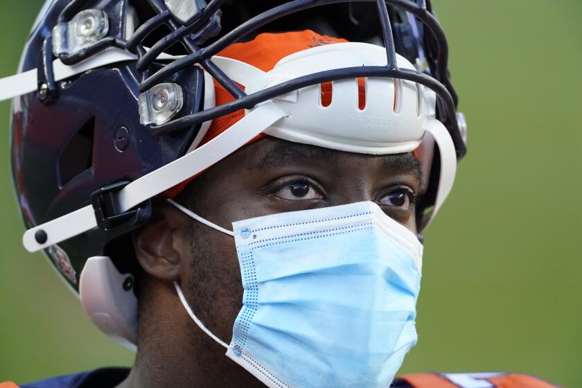 Denver Broncos offensive tackle Calvin Anderson looks on while wearing a mask against the New Orleans Saints during an NFL football game Sunday, Nov. 29, 2020, in Denver. (AP Photo/Jack Dempsey)