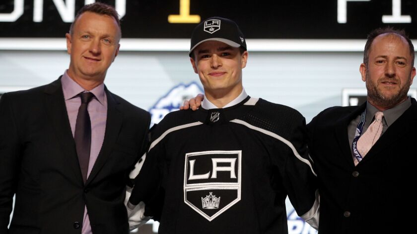 Alex Turcotte, center, reacts after being selected fifth overall by the Kings during the first round of the NHL draft on Friday in Vancouver.