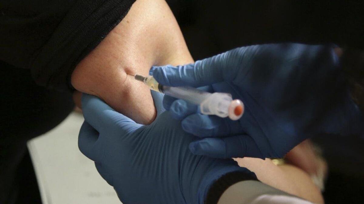 A woman receives a measles, mumps and rubella vaccine in Pomona, N.Y., on March 27.