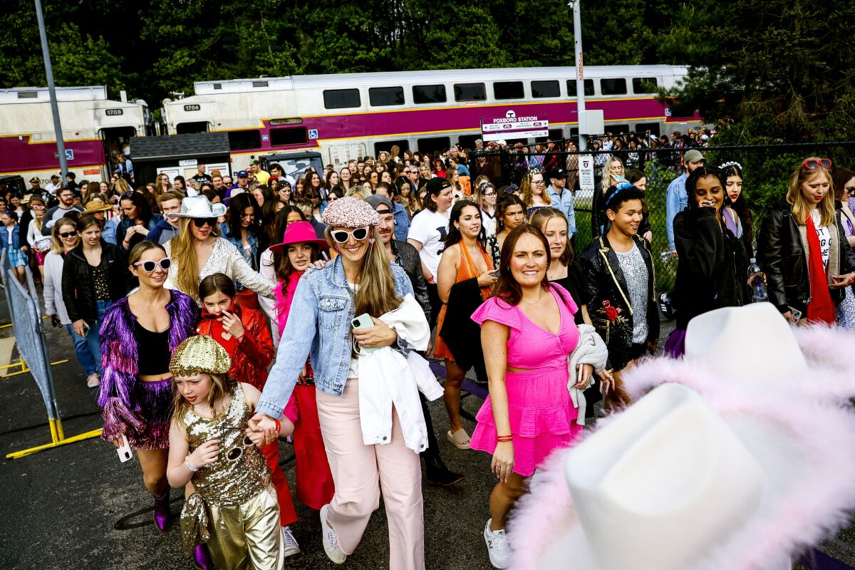 Fans arriving for a concert at a stadium. 