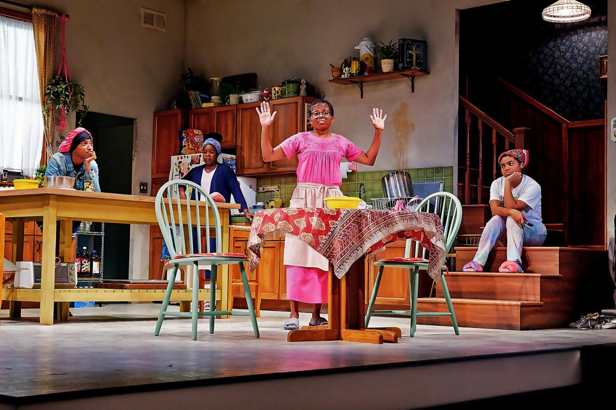 A group of actors portrays a multigenerational group of Black women on a kitchen set in Zora Howard's "Stew."