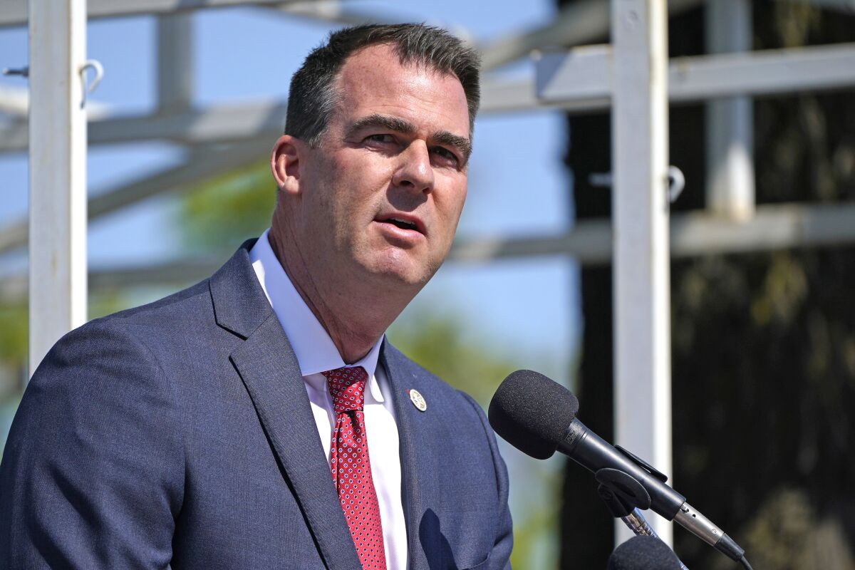 FILE - In this May 7, 2021, file photo, Oklahoma Gov. Kevin Stitt speaks during an Oklahoma Law Enforcement Memorial Ceremony in Oklahoma City. Oklahoma is making voting slightly easier, a contrast to other Republican-led states. Republican Gov. Stitt recently signed a bill that adds a day of early voting and makes changes to ensure mail-in ballots are received in time to be counted. (AP Photo/Sue Ogrocki File)
