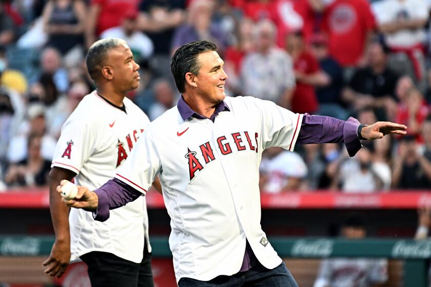 Anaheim, California April 7 2022- Former Angels Garrett Anderson and Tim Salmon throw out the first pitch on opening day at Angel Stadium of Anaheim. (Wally Skalij/Los Angeles Times)