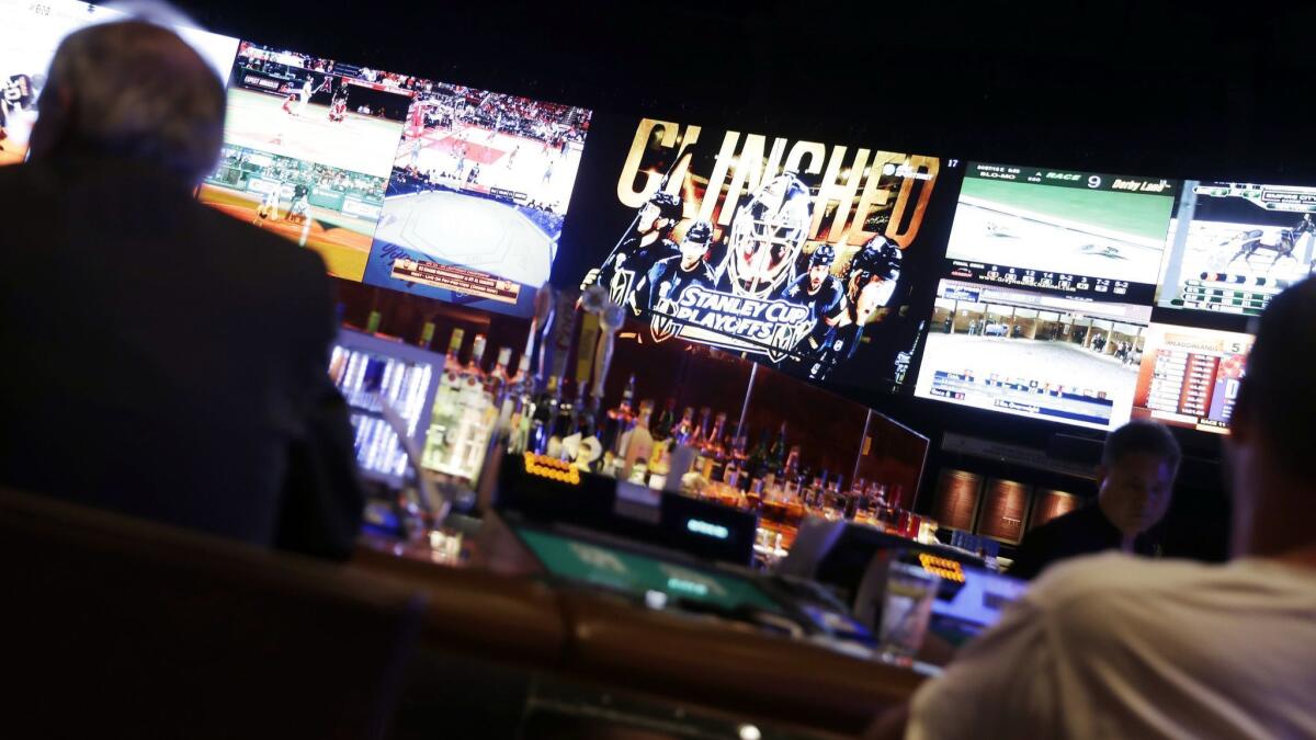 The Golden Knights final regular season game against the Calgary Flames is displayed on big screens at the sport book inside Caesars Palace.