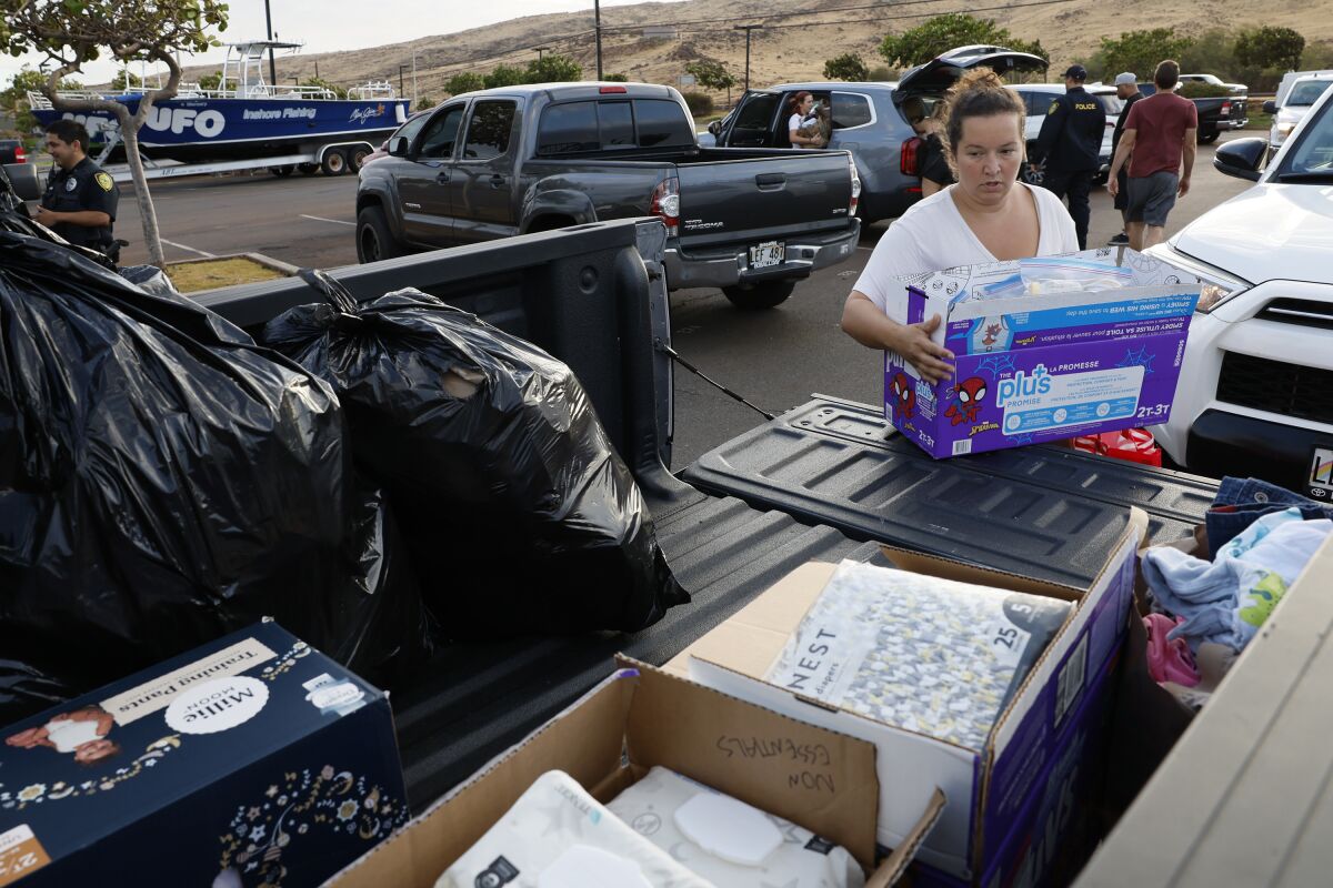 Brittany Harris with boxes and bags of supplies